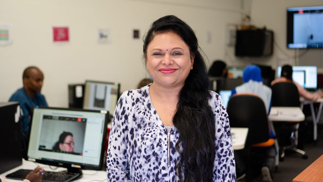 Trainer in a computer lab with students