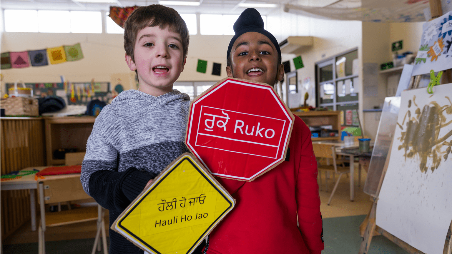 kids hold some signs in their languages