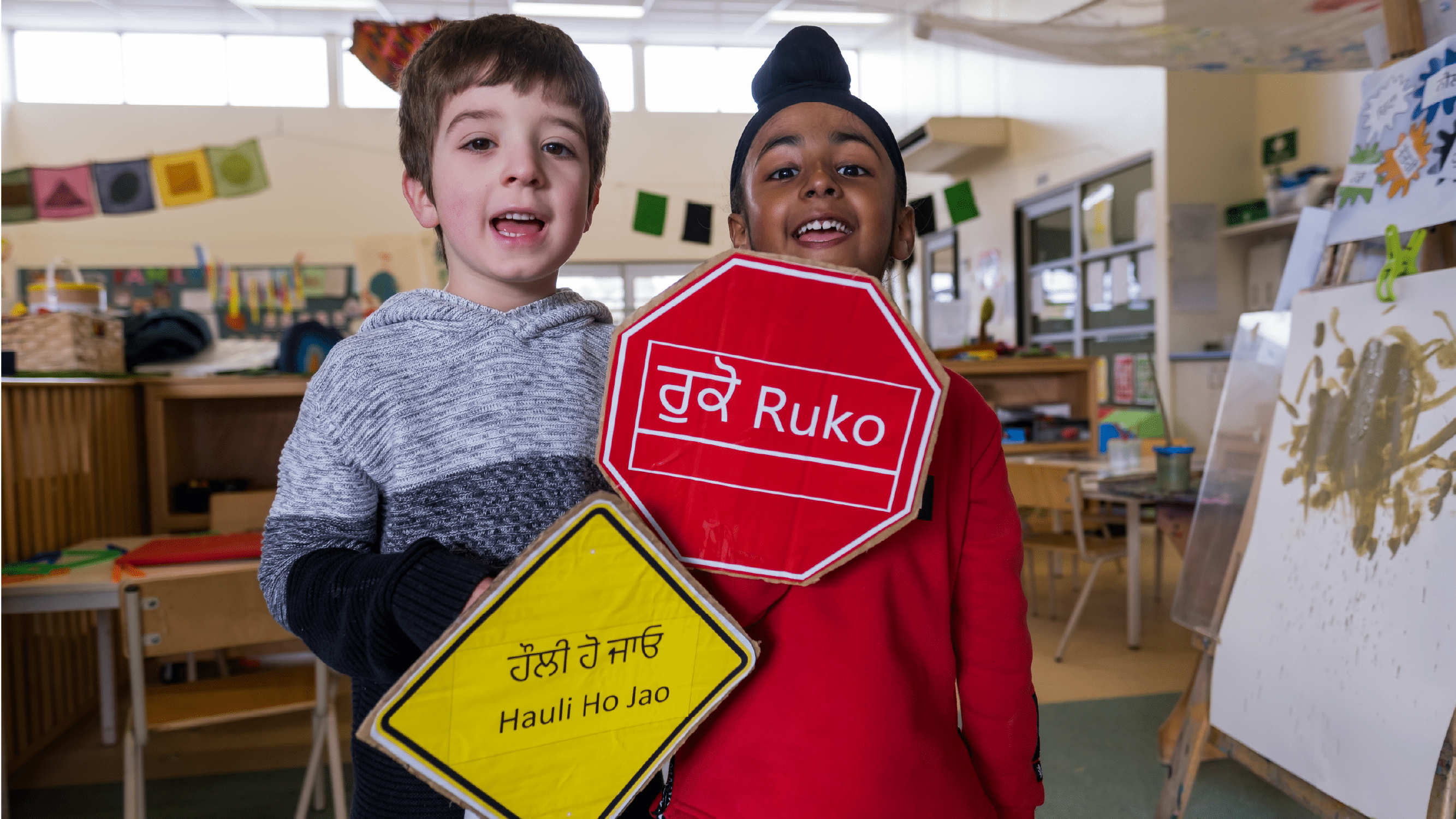 kids hold some signs in their languages