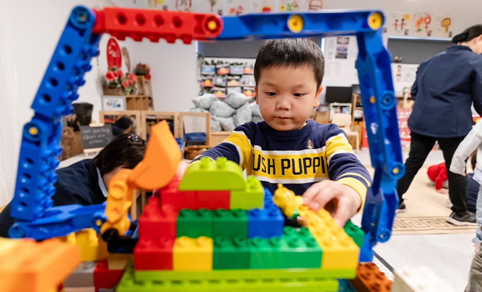 A child building a digger with blocks