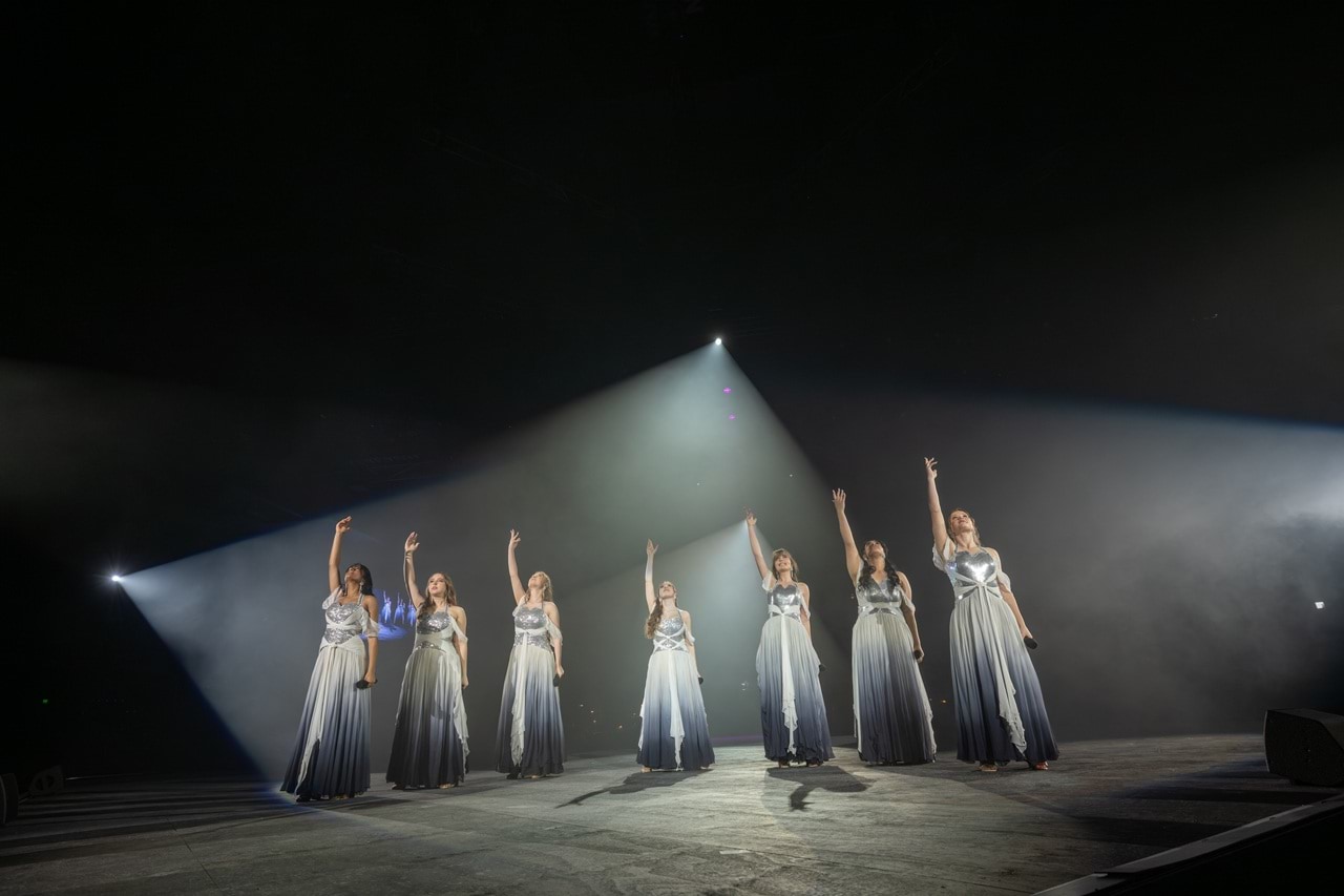 Singers performing on stage.
