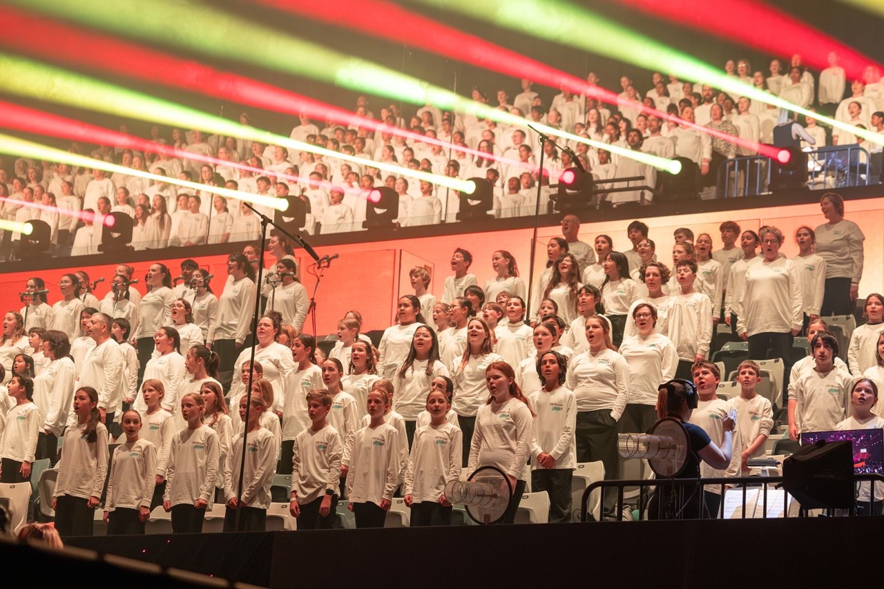 Students singing in a large choir.