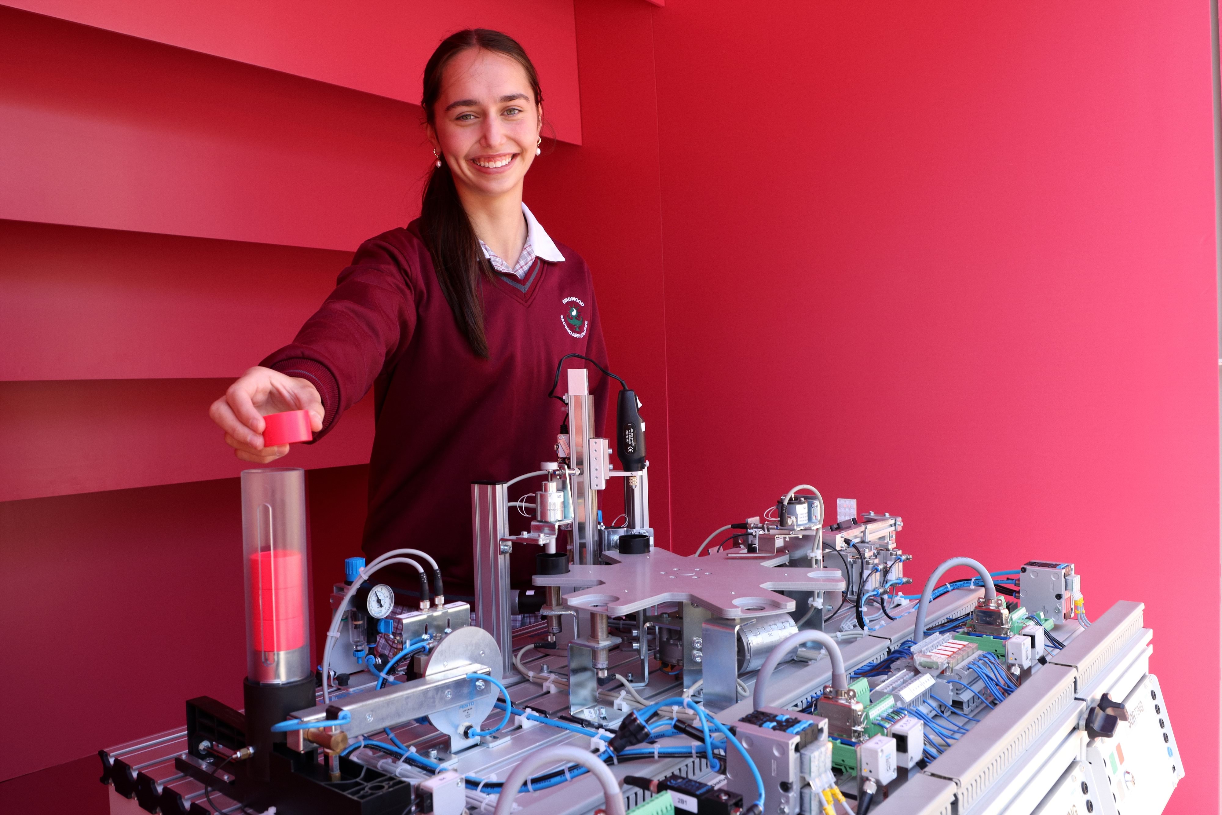 High school aged female student working on an engineering piece