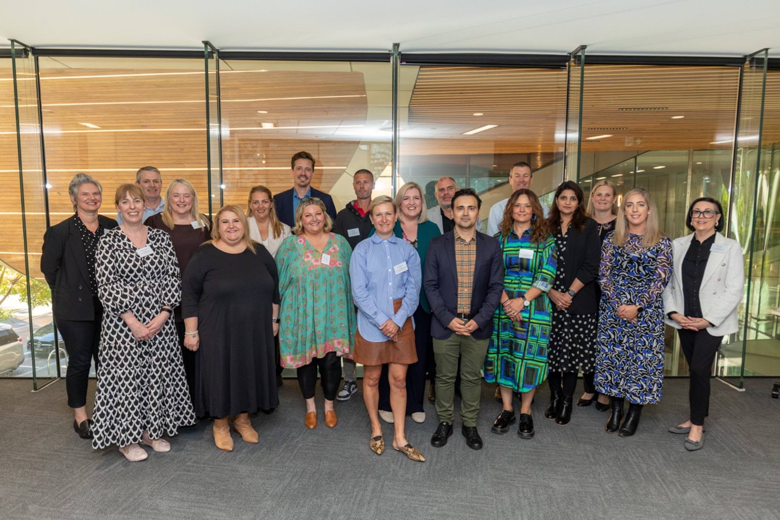 A group of school principals standing side by side, posing for a photo