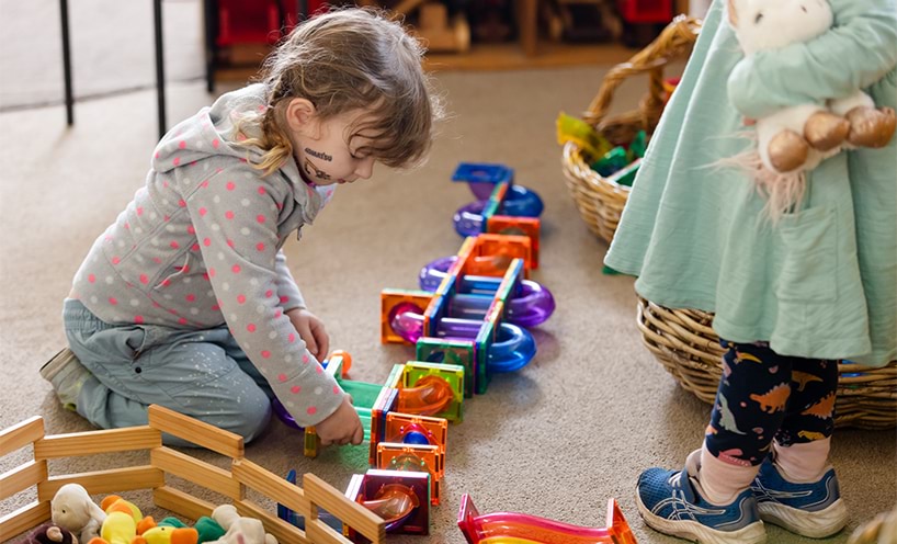 A child playing with magnetic educational building blocks