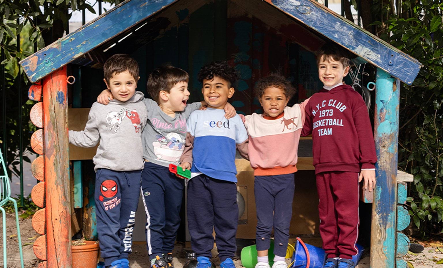 5 children standing in a cubby
